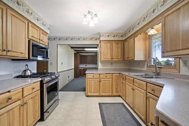 7704 Salisbury Rd, West Bend, WI 53090 - kitchen with appliances with stainless steel finishes, a sink, light countertops, and light flooring