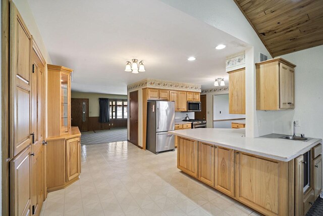 7704 Salisbury Rd, West Bend, WI 53090 - kitchen featuring appliances with stainless steel finishes, a sink, a peninsula, light countertops, and recessed lighting