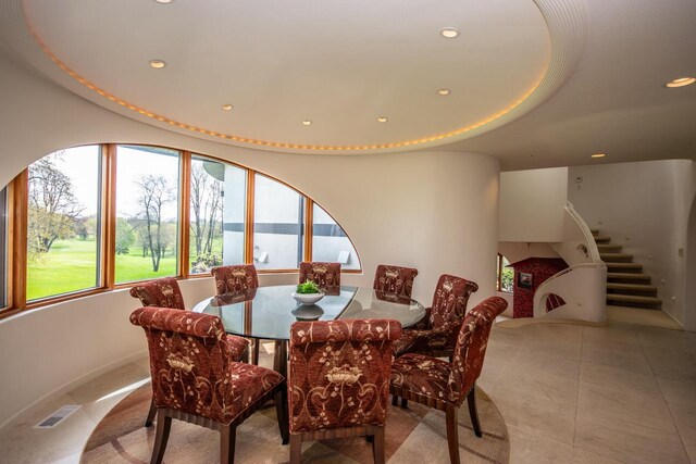4455 Club Dr, Slinger, WI 53086 - dining space featuring recessed lighting, light tile patterned floors, and stairs