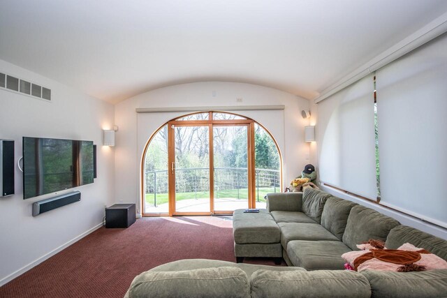 4455 Club Dr, Slinger, WI 53086 - carpeted living area featuring baseboards and lofted ceiling