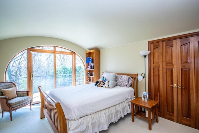4455 Club Dr, Slinger, WI 53086 - bedroom featuring light colored carpet, access to exterior, and lofted ceiling