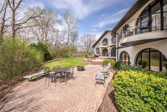 4455 Club Dr, Slinger, WI 53086 - view of patio / terrace featuring a balcony, a fire pit, and outdoor dining space