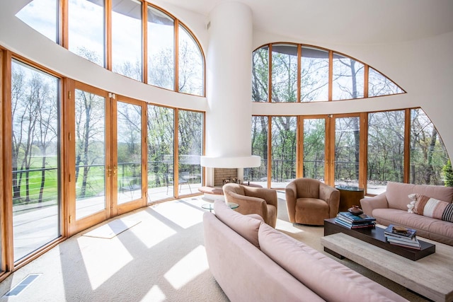 4455 Club Dr, Slinger, WI 53086 - living area featuring french doors, carpet flooring, a towering ceiling, and plenty of natural light