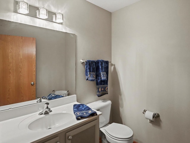 bathroom with toilet and vanity