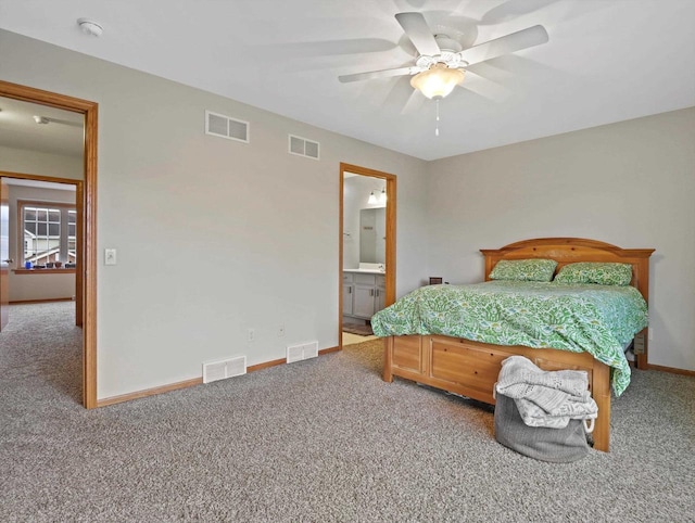 bedroom with carpet flooring, baseboards, a ceiling fan, and connected bathroom