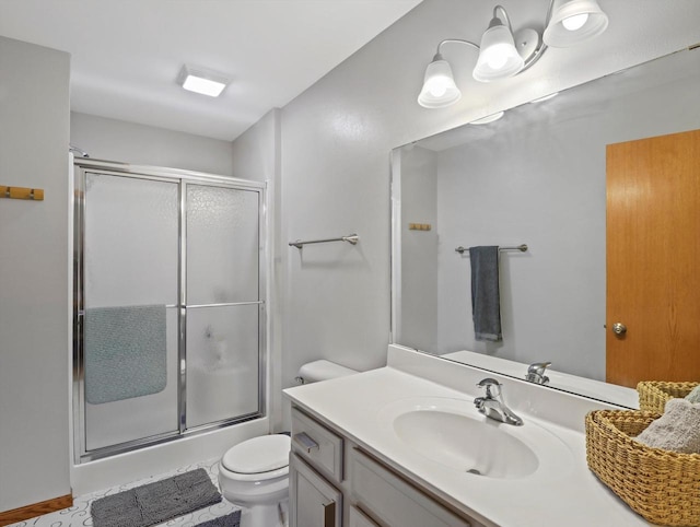 full bathroom featuring an enclosed shower, toilet, and vanity
