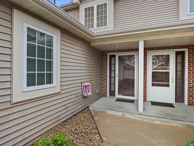 property entrance with brick siding