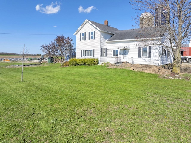 N3685 Mitchell Rd, Campbellsport, WI 53010 - back of house featuring a chimney and a yard