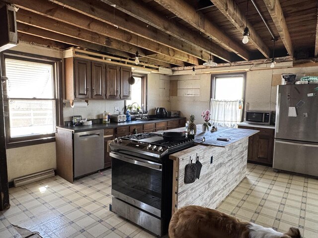 N3685 Mitchell Rd, Campbellsport, WI 53010 - kitchen featuring stainless steel appliances, light flooring, a sink, dark countertops, and dark brown cabinets