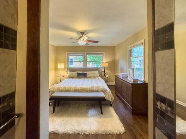 7814 2nd Ave, Kenosha, WI 53143 - bedroom with dark wood-type flooring, ceiling fan, and baseboards