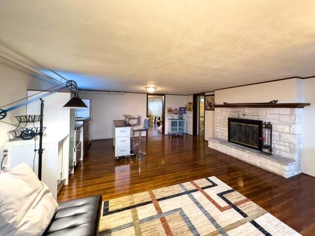 7814 2nd Ave, Kenosha, WI 53143 - living room with wood finished floors and a stone fireplace