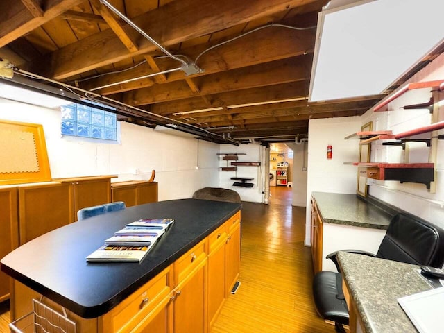 7814 2nd Ave, Kenosha, WI 53143 - kitchen featuring wood finished floors, a center island, dark countertops, and open shelves