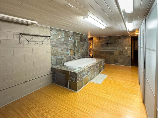 7814 2nd Ave, Kenosha, WI 53143 - full bath with wood finished floors, concrete block wall, and a bath