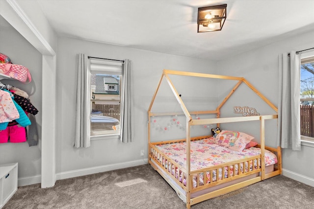 bedroom featuring carpet and baseboards