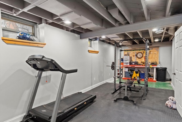 workout area featuring carpet and baseboards
