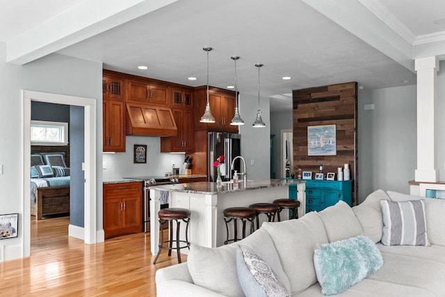 519 Park Ave, Little Chute, WI 54140 - kitchen with stainless steel appliances, open floor plan, a kitchen bar, recessed lighting, and premium range hood
