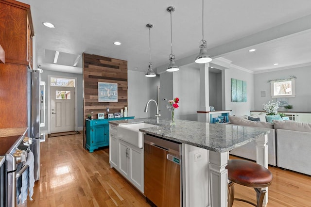 519 Park Ave, Little Chute, WI 54140 - kitchen with stainless steel appliances, a sink, plenty of natural light, light wood finished floors, and recessed lighting