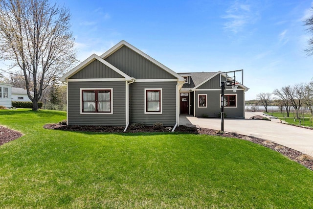 519 Park Ave, Little Chute, WI 54140 - view of front of house featuring a front yard and board and batten siding