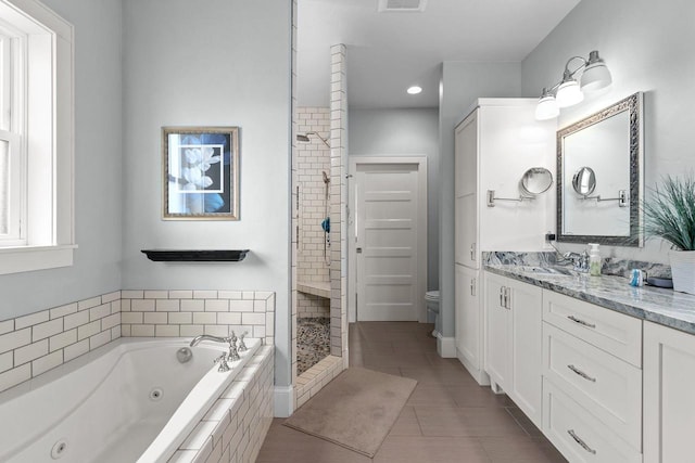 519 Park Ave, Little Chute, WI 54140 - bathroom featuring toilet, a whirlpool tub, vanity, tile patterned flooring, and a stall shower