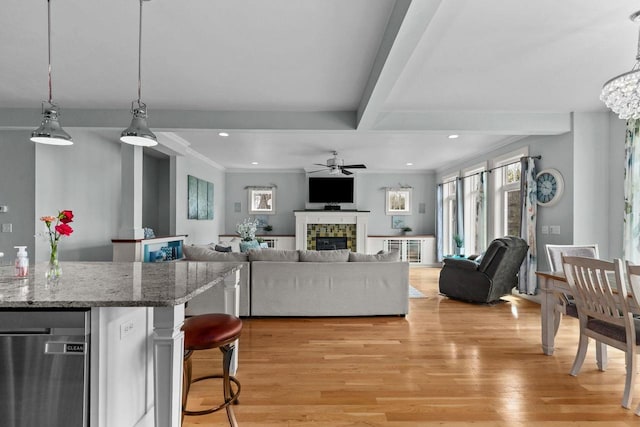 519 Park Ave, Little Chute, WI 54140 - living room with ceiling fan, light wood-style flooring, a fireplace, beam ceiling, and recessed lighting