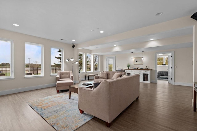 519 Park Ave, Little Chute, WI 54140 - living room featuring wood finished floors, baseboards, beverage cooler, and recessed lighting