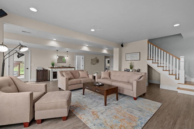 519 Park Ave, Little Chute, WI 54140 - living room featuring wood finished floors, stairs, recessed lighting, and baseboards