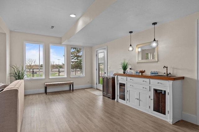 519 Park Ave, Little Chute, WI 54140 - bar featuring baseboards and light wood-type flooring