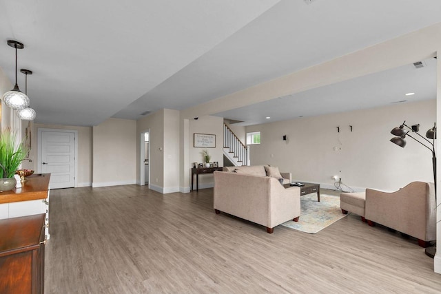 519 Park Ave, Little Chute, WI 54140 - living area featuring light wood-style floors, stairs, and baseboards