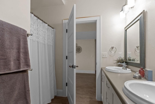 519 Park Ave, Little Chute, WI 54140 - bathroom with wood finished floors, double vanity, and baseboards