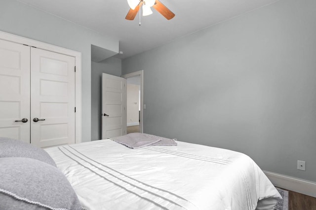 519 Park Ave, Little Chute, WI 54140 - bedroom with dark wood-style flooring, a closet, ceiling fan, and baseboards