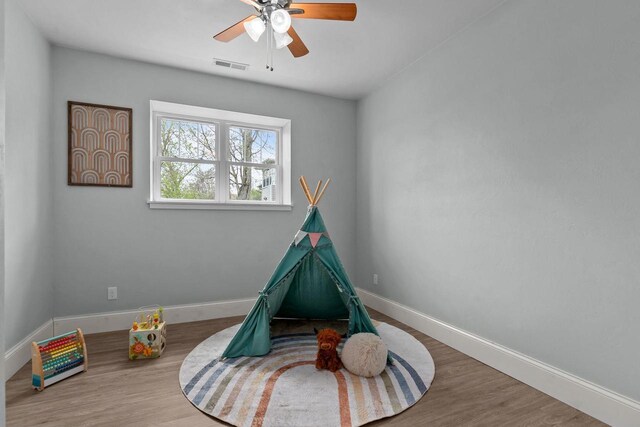 519 Park Ave, Little Chute, WI 54140 - rec room with baseboards, a ceiling fan, and wood finished floors