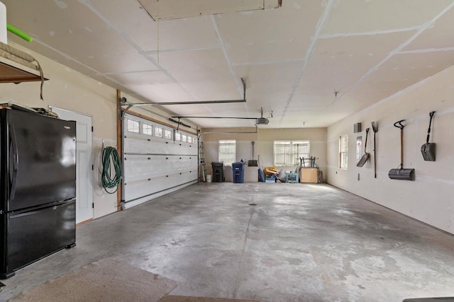 519 Park Ave, Little Chute, WI 54140 - garage with freestanding refrigerator and a garage door opener