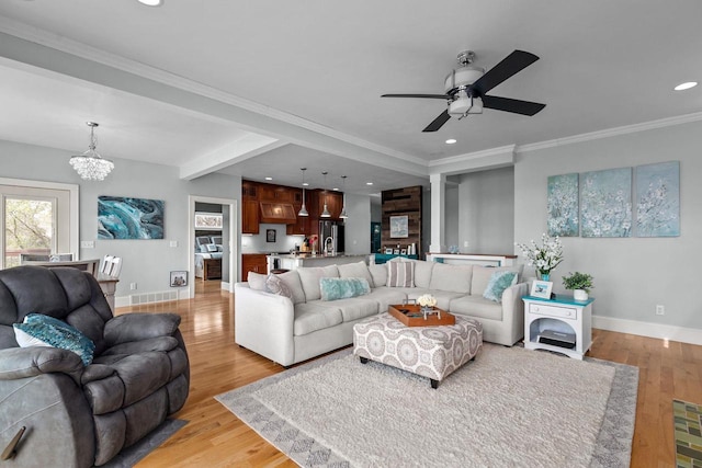 519 Park Ave, Little Chute, WI 54140 - living room featuring a chandelier, baseboards, light wood-style flooring, ceiling fan, and recessed lighting