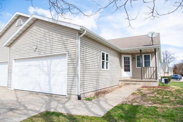 624 Westwynd Ct, Mazomanie, WI 53560 - view of side of home featuring a porch, an attached garage, central air condition unit, and concrete driveway