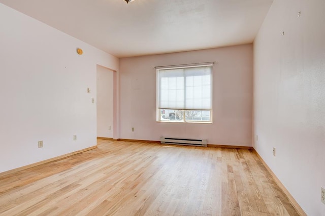 1600 26th Ave, Menominee, MI 49858 - spare room featuring a baseboard heating unit, light wood-style floors, and baseboards