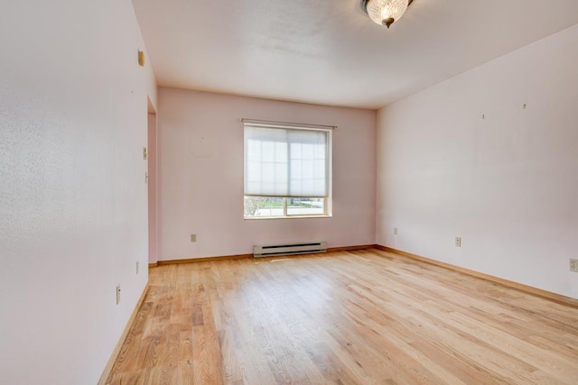 1600 26th Ave, Menominee, MI 49858 - spare room with a baseboard radiator, light wood-type flooring, and baseboards