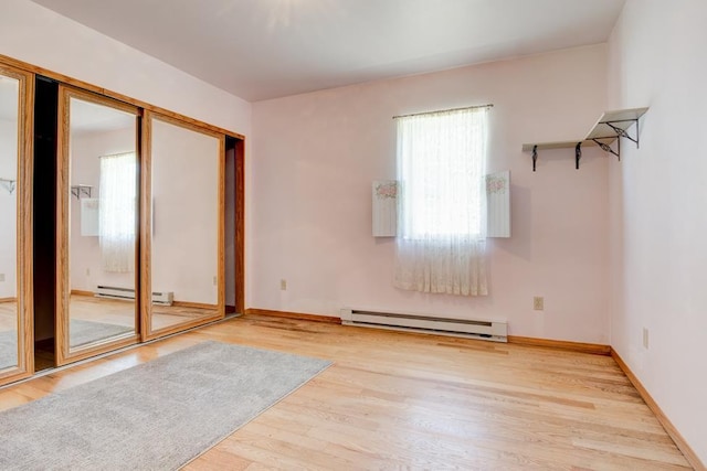 1600 26th Ave, Menominee, MI 49858 - empty room featuring baseboard heating, wood finished floors, and baseboards