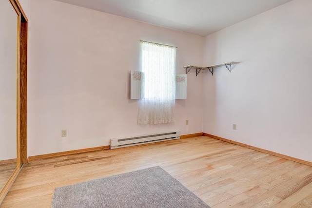 1600 26th Ave, Menominee, MI 49858 - unfurnished room with a baseboard radiator, wood finished floors, and baseboards