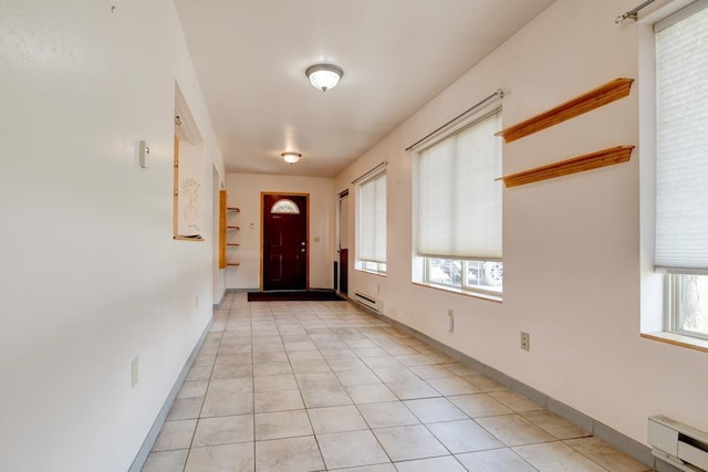 1600 26th Ave, Menominee, MI 49858 - entryway with a baseboard radiator, a baseboard heating unit, light tile patterned flooring, and baseboards