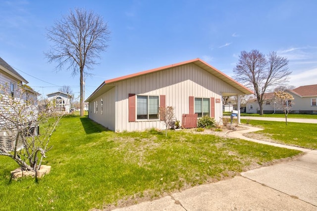 1600 26th Ave, Menominee, MI 49858 - manufactured / mobile home featuring a front yard, board and batten siding, and driveway