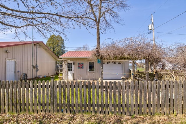 1600 26th Ave, Menominee, MI 49858 - view of front of home with a fenced front yard, metal roof, and an attached garage