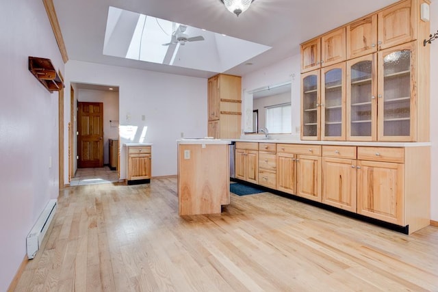 1600 26th Ave, Menominee, MI 49858 - kitchen featuring a baseboard heating unit, light wood-style floors, a ceiling fan, a sink, and light brown cabinets