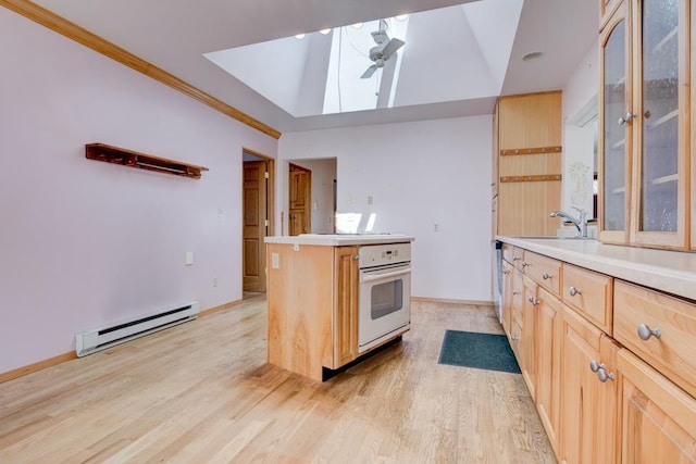 1600 26th Ave, Menominee, MI 49858 - kitchen featuring baseboard heating, oven, light brown cabinetry, ceiling fan, and ornamental molding