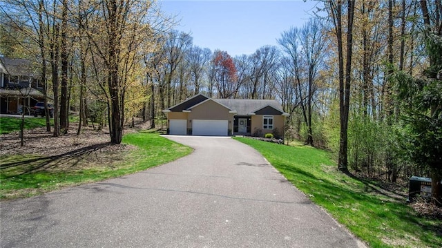 129 Grey Friar Ln, Eau Claire, WI 54701 - single story home featuring an attached garage, asphalt driveway, and a front lawn