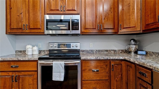 129 Grey Friar Ln, Eau Claire, WI 54701 - kitchen with stainless steel appliances and brown cabinets