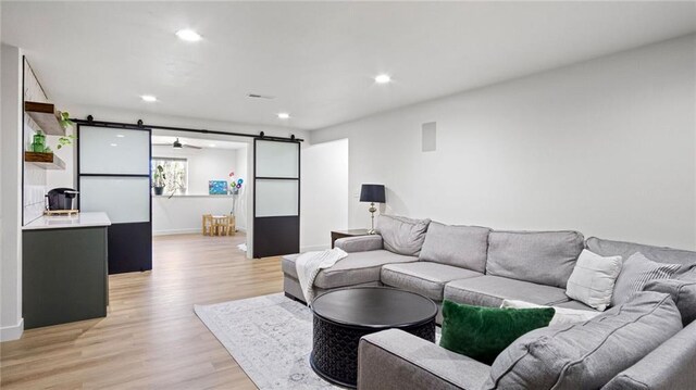 129 Grey Friar Ln, Eau Claire, WI 54701 - living area featuring a barn door, light wood-style floors, recessed lighting, and baseboards