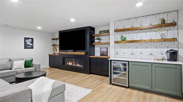 129 Grey Friar Ln, Eau Claire, WI 54701 - indoor dry bar featuring wine cooler, light wood-style floors, a large fireplace, recessed lighting, and baseboards