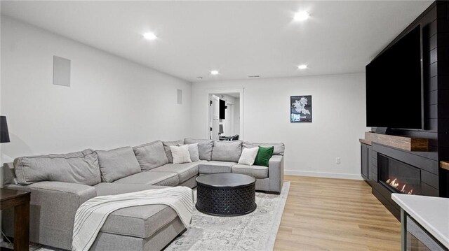 129 Grey Friar Ln, Eau Claire, WI 54701 - living area featuring recessed lighting, a glass covered fireplace, light wood-style flooring, and baseboards