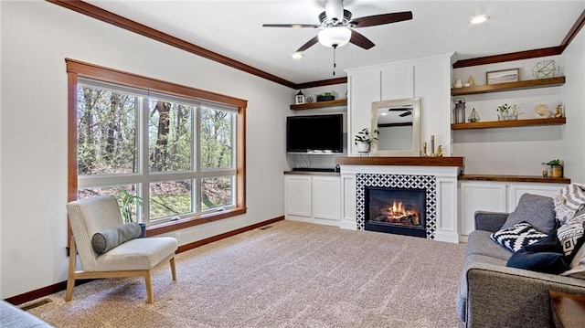 129 Grey Friar Ln, Eau Claire, WI 54701 - living room featuring a ceiling fan, baseboards, crown molding, a tile fireplace, and light colored carpet