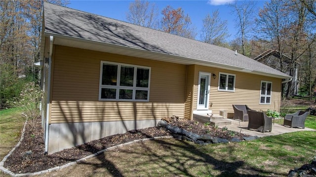129 Grey Friar Ln, Eau Claire, WI 54701 - rear view of house featuring a patio area, roof with shingles, and a lawn